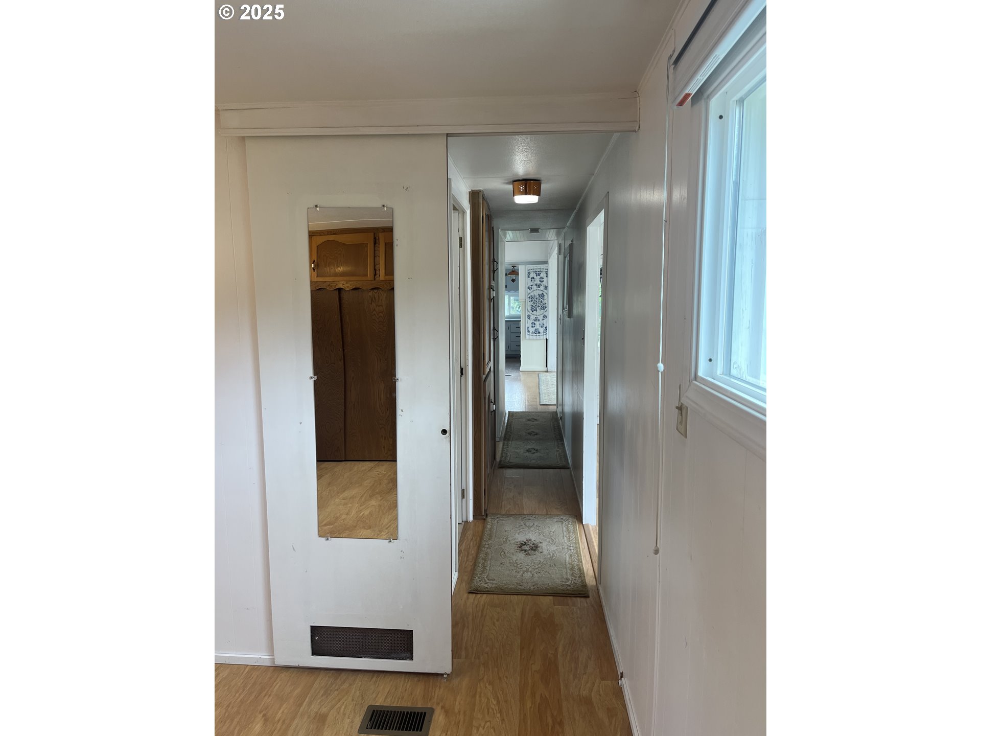 83763 Highway 101, Unit 14 Florence, OR 97439 - Photo 17 of 33 a view of a hallway with wooden floor