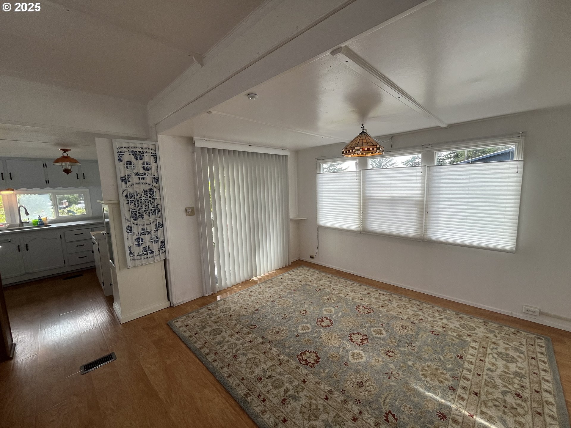 83763 Highway 101, Unit 14 Florence, OR 97439 - Photo 2 of 33 a view of a hallway to rooms and wooden floor