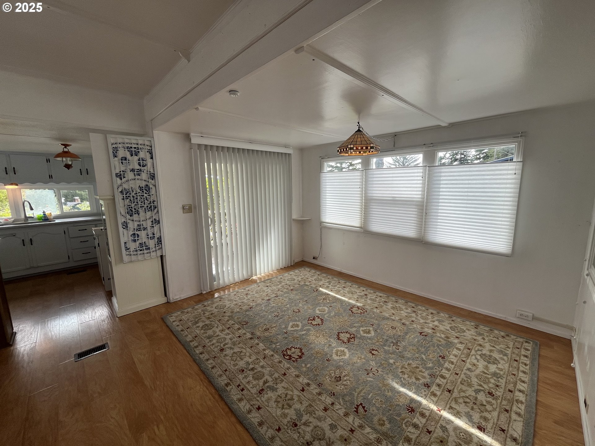 83763 Highway 101, Unit 14 Florence, OR 97439 - Photo 3 of 33 wooden floor in an empty room with a window
