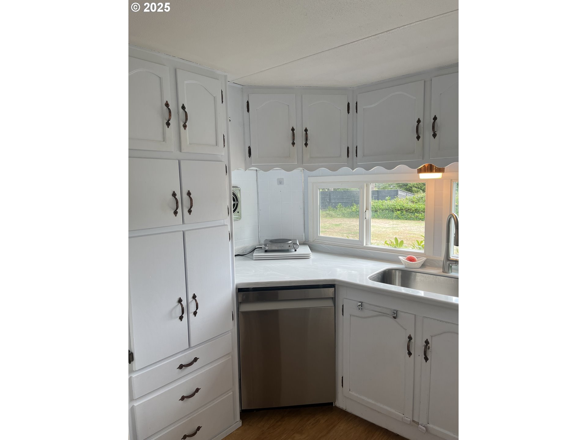 83763 Highway 101, Unit 14 Florence, OR 97439 - Photo 8 of 33 a kitchen with a sink and cabinets