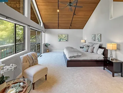 a bedroom with furniture and a large window