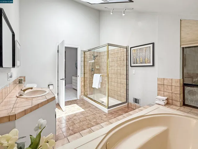 a bedroom with a bed and painting on the wall