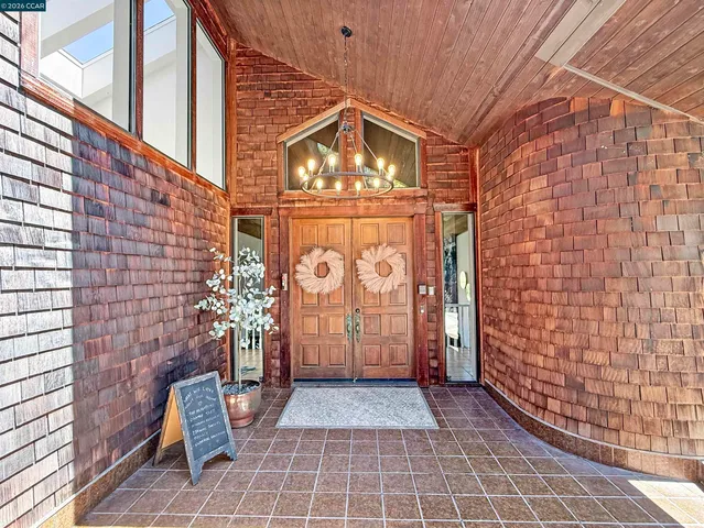 a view of a balcony with wooden floor and fence