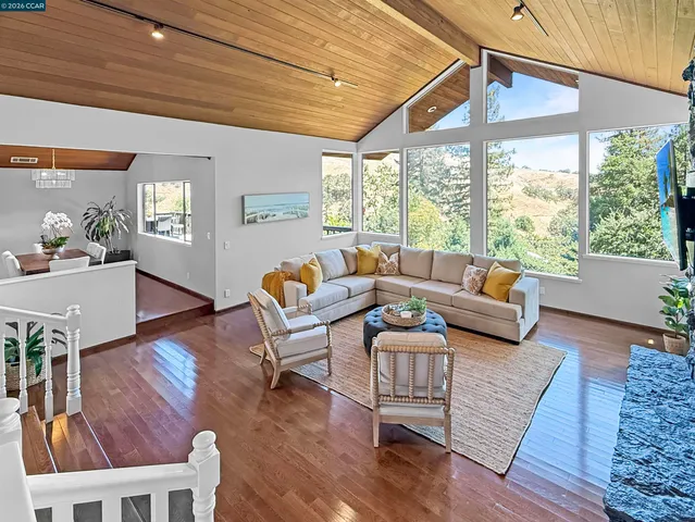 a view of balcony with floor to ceiling windows and wooden floor