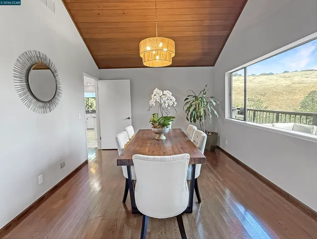 a kitchen with kitchen island granite countertop a stove a sink a counter space and cabinets