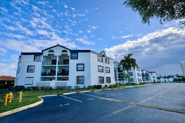 a front view of a house with a yard and tree s