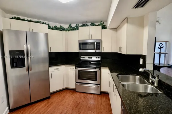 a kitchen with a refrigerator sink and microwave