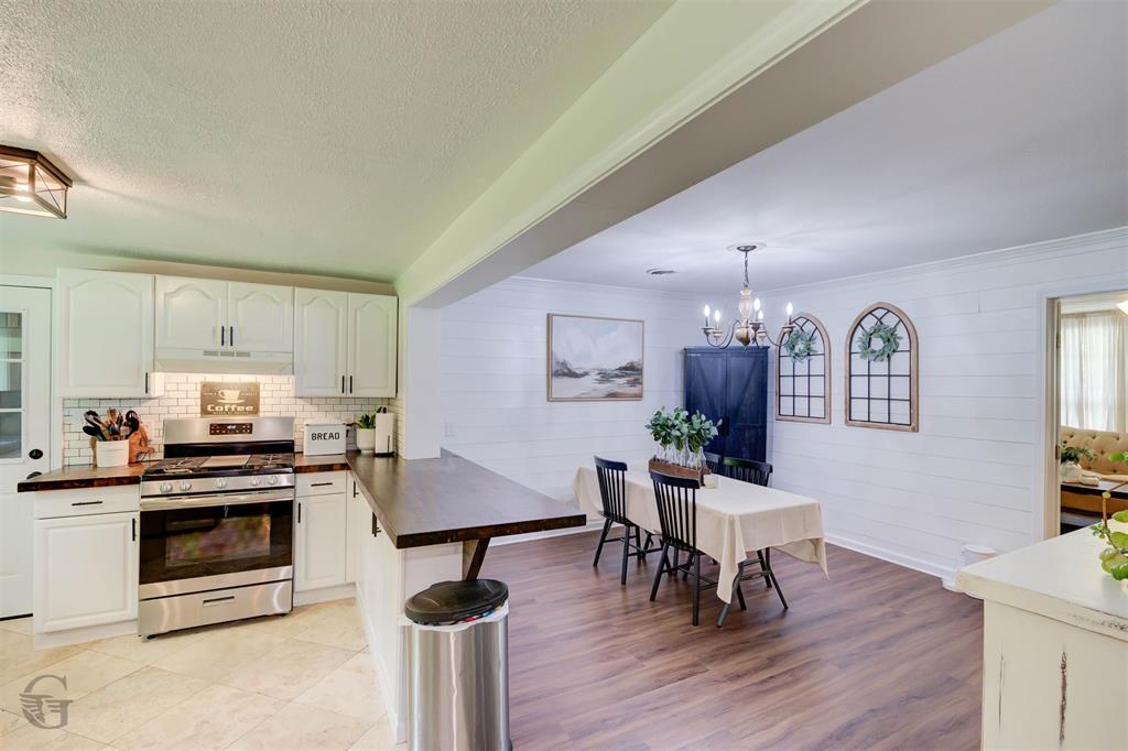 701 Chandler Road Haughton, LA 71037 - Photo 8 of 25 a living room with furniture a dining table wooden floor and a fireplace