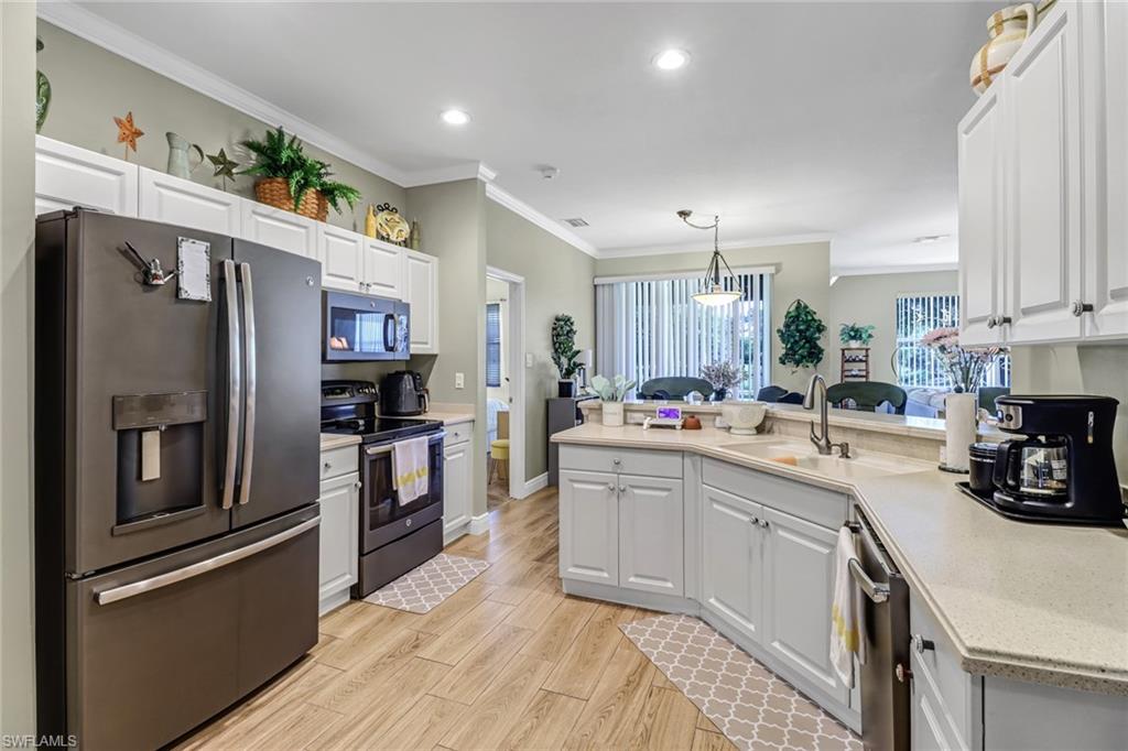 a kitchen with stainless steel appliances and refrigerator