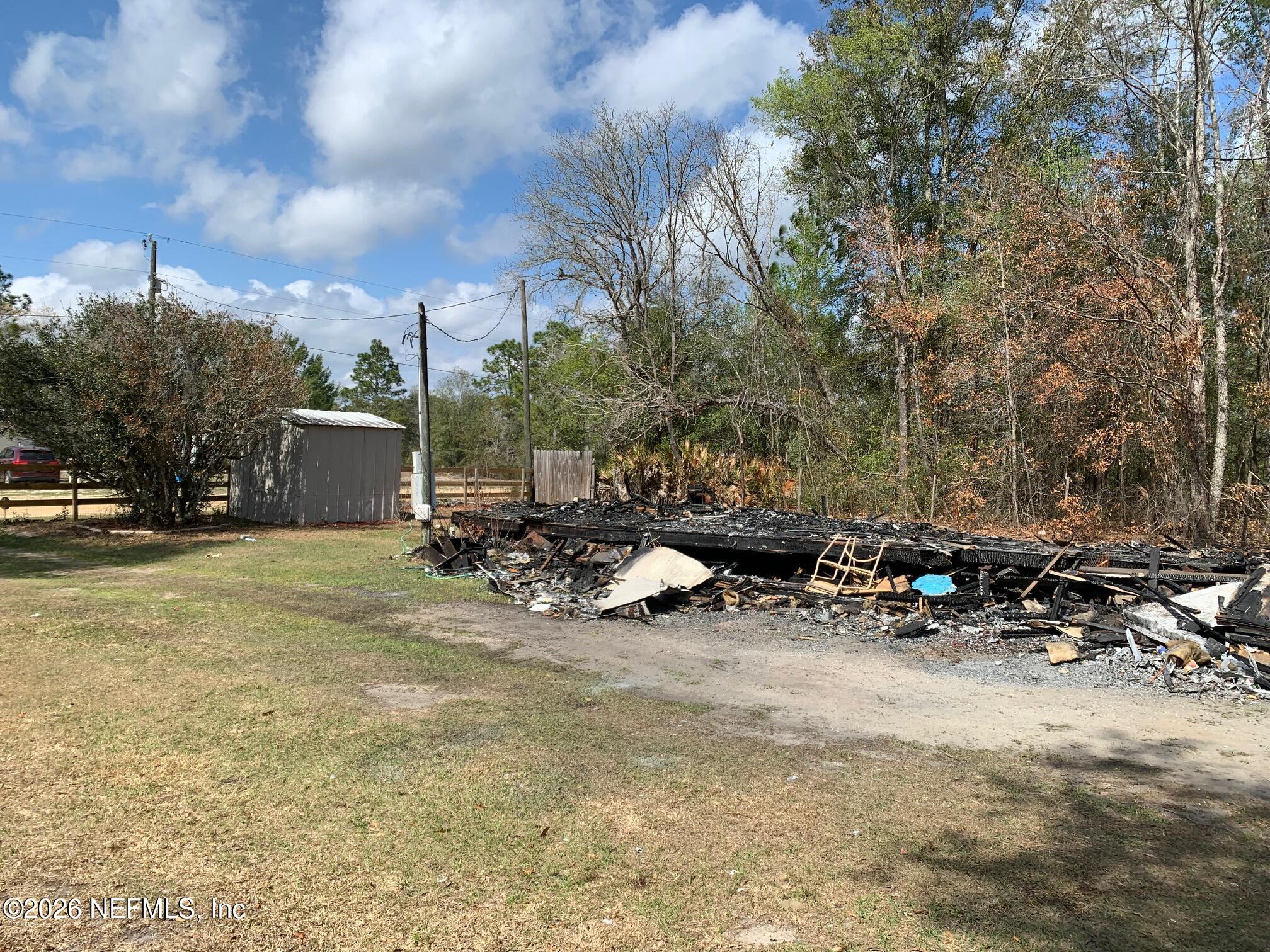 234 Maltas Avenue Interlachen, FL 32148 - Photo 5 of 9 a view of a backyard with table and chairs and a fire pit