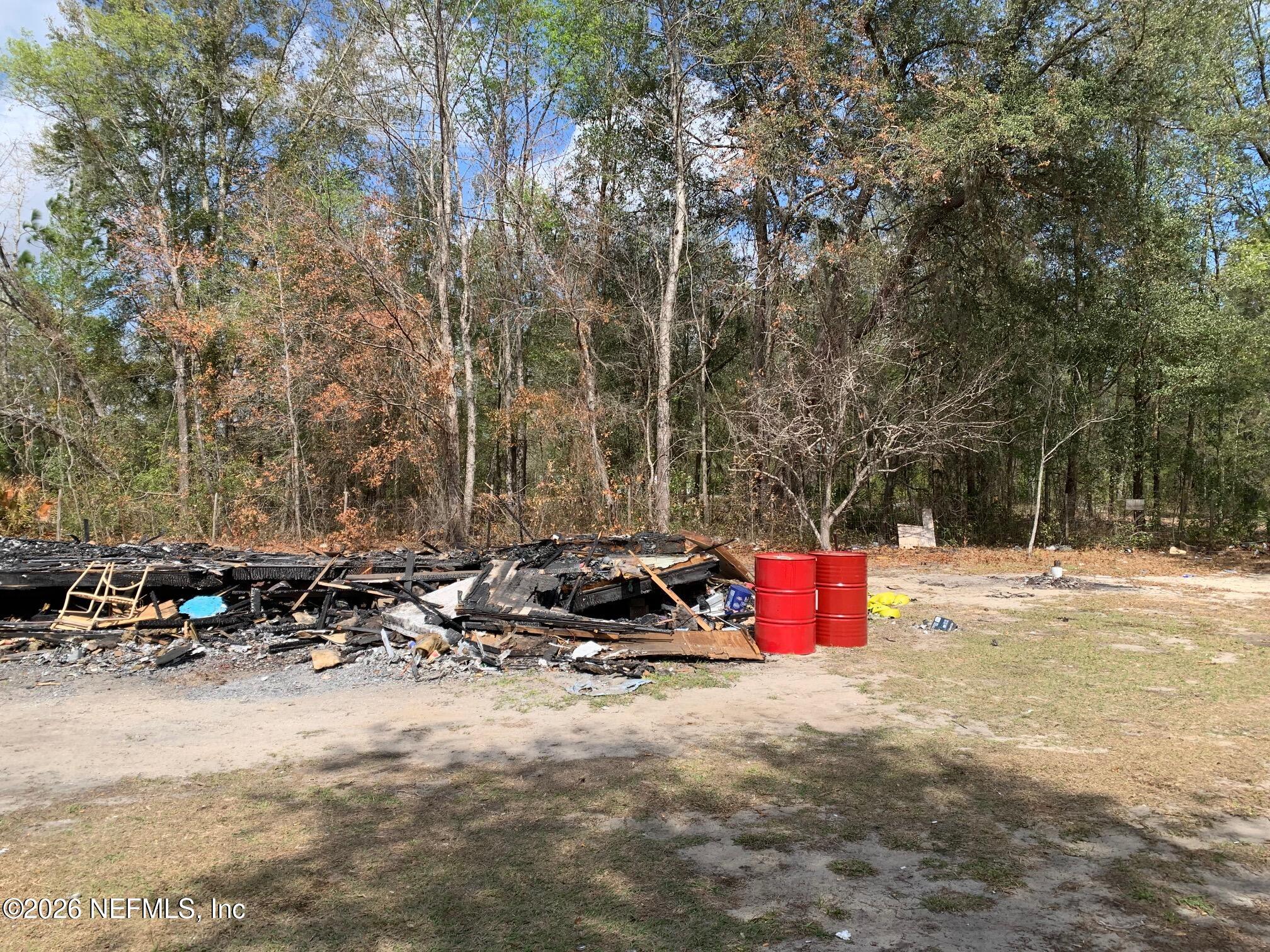 234 Maltas Avenue Interlachen, FL 32148 - Photo 6 of 9 a backyard of a house with cars parked