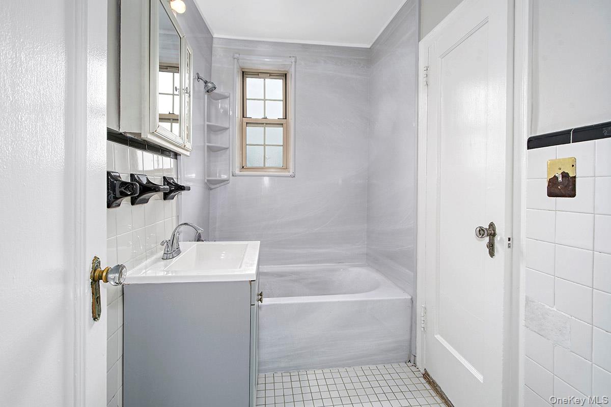 151 Centre Avenue, Unit 5D New Rochelle, NY 10805 - Photo 13 of 17 a bathroom with a sink a toilet and shower