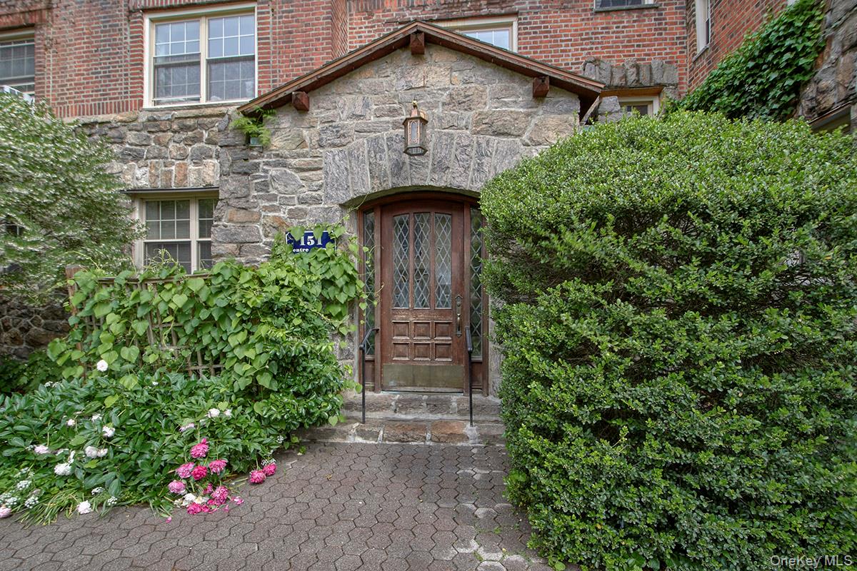 151 Centre Avenue, Unit 5D New Rochelle, NY 10805 - Photo 15 of 17 a front view of a house with a garden