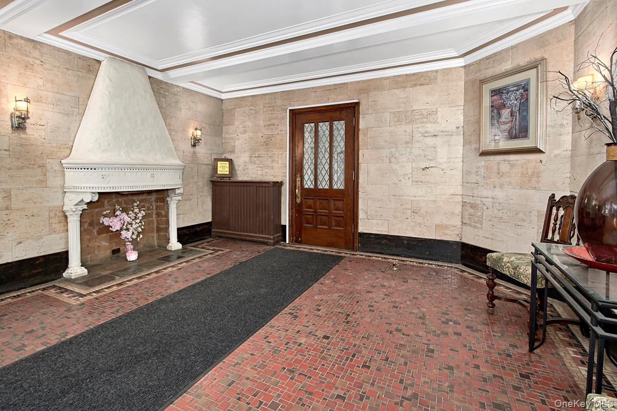 151 Centre Avenue, Unit 5D New Rochelle, NY 10805 - Photo 16 of 17 a living room with furniture a fireplace and a table