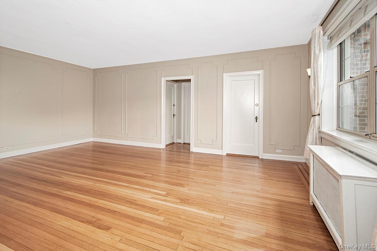 151 Centre Avenue, Unit 5D New Rochelle, NY 10805 - Photo 5 of 17 a view of empty room with wooden floor and fan
