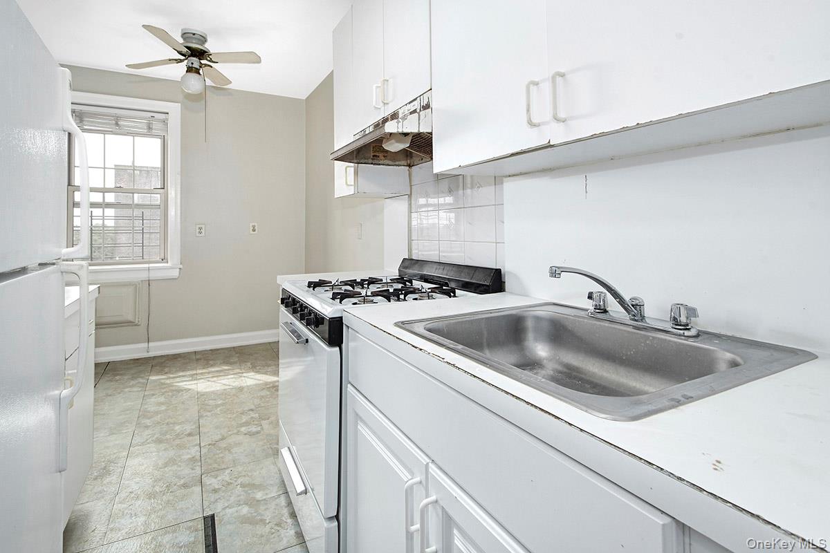 151 Centre Avenue, Unit 5D New Rochelle, NY 10805 - Photo 7 of 17 a kitchen with a sink cabinets and window