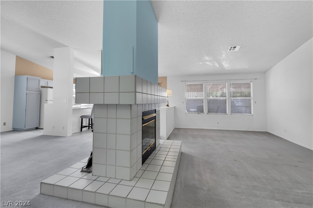212 Pocahontas Court Henderson, NV 89074 - Photo 6 of 28 view of fireplace with living room to right and ki