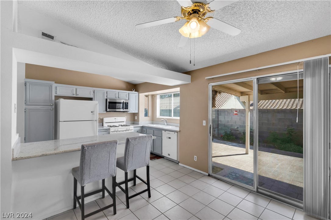212 Pocahontas Court Henderson, NV 89074 - Photo 9 of 28 view of kitchen and back slider