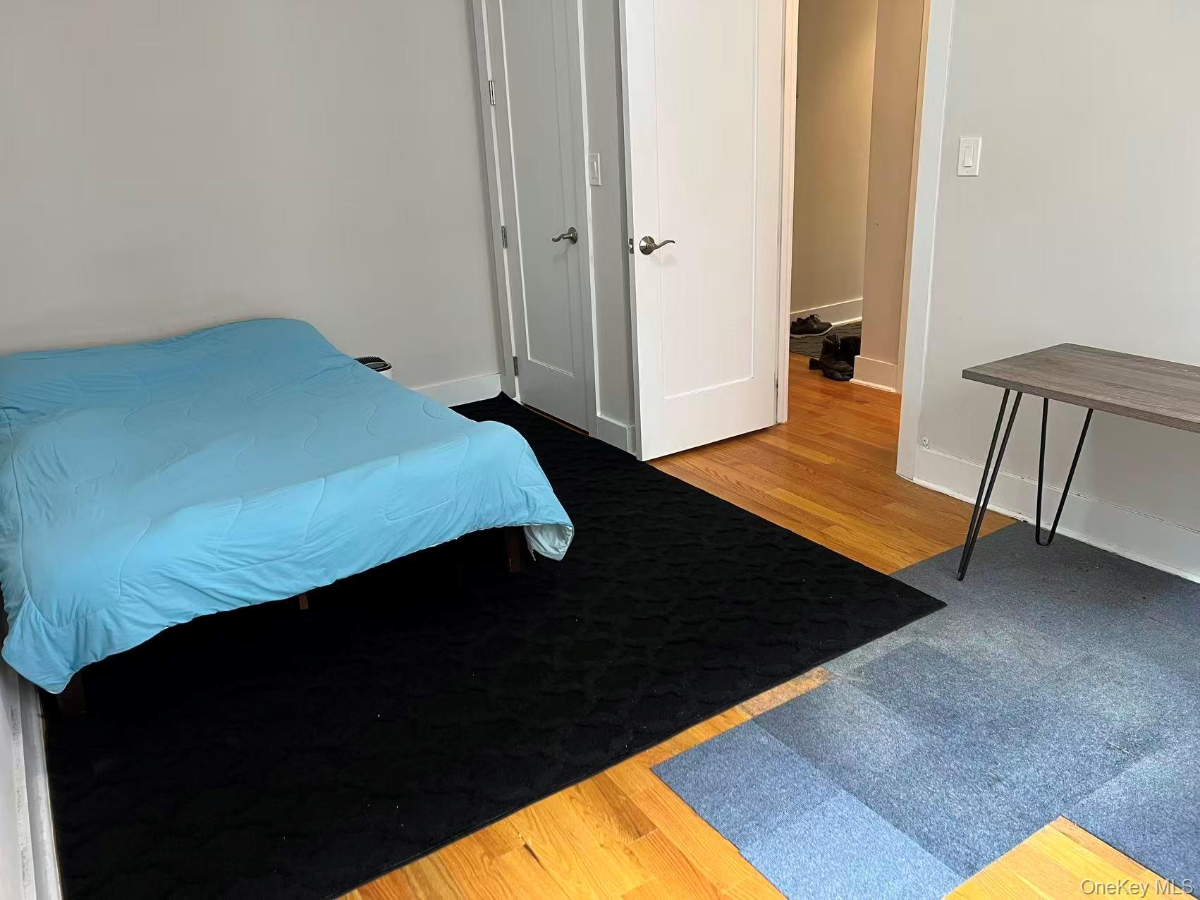 42-22 Ketcham Street, Unit 3E Queens, NY 11373 - Photo 7 of 8 a view of bedroom with furniture and wooden floor