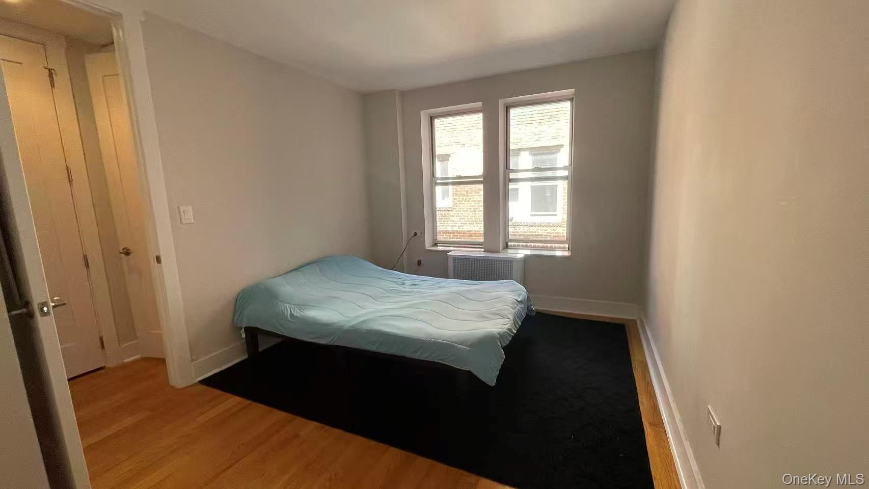 42-22 Ketcham Street, Unit 3E Queens, NY 11373 - Photo 8 of 8 a bedroom with a bed and a window