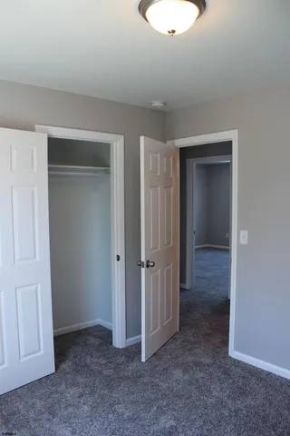 an empty room with closet area