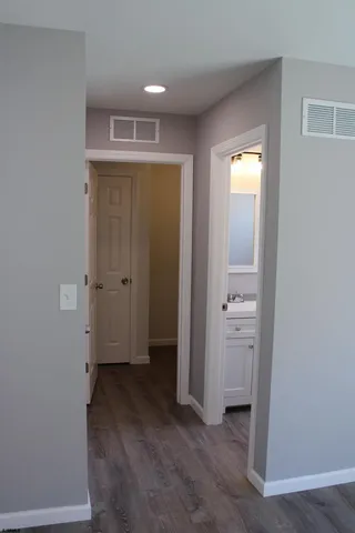 an empty room with closet and a bathroom