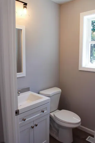 a white toilet sitting next to a bathroom sink