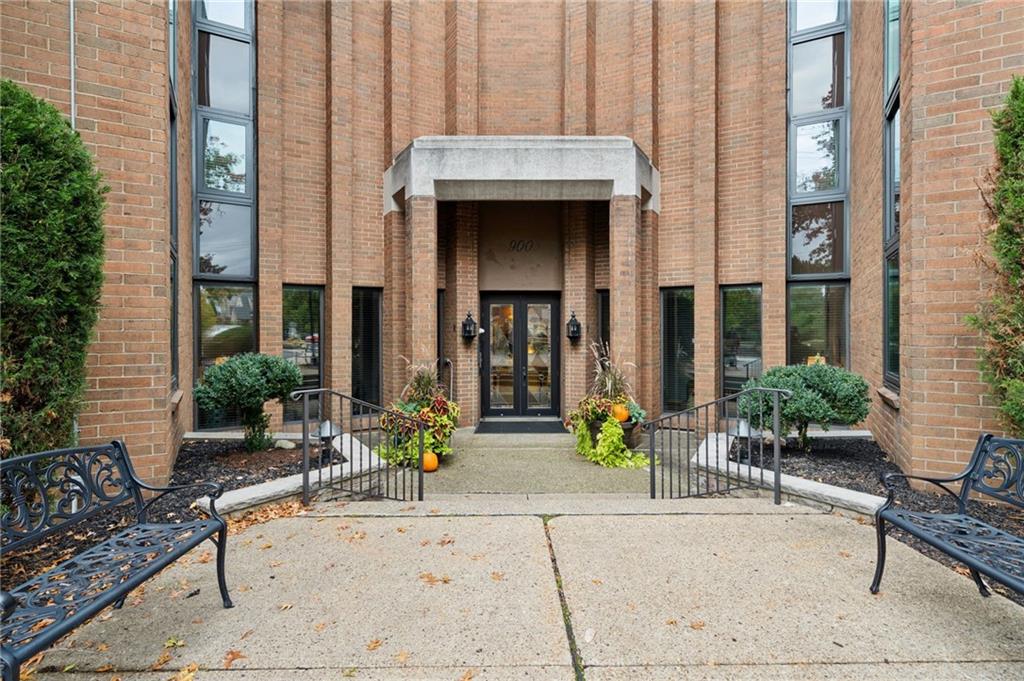 a view of a house with potted plants