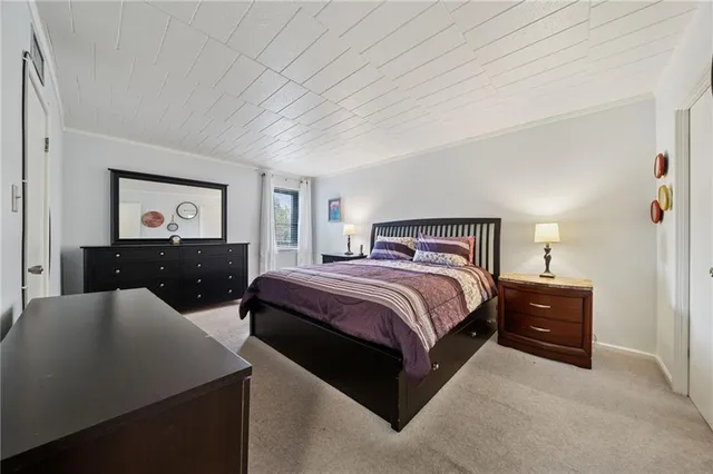 a bedroom with a bed and a night stand