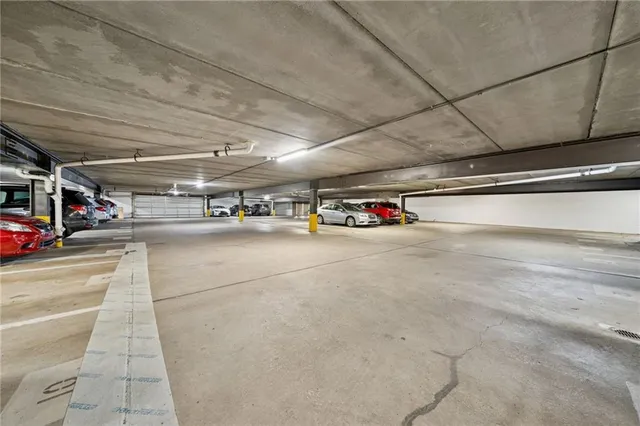 a living room with furniture a wooden floor and next to a window