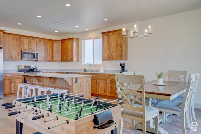 1329 Paseos Street Washington, UT 84780 - Photo 13 of 35 Kitchen with a center island, stainless steel microwave, light wood-style flooring, and recessed lighting
