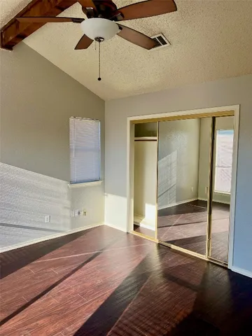 a view of a room with wooden floor