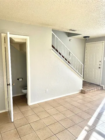 a view of a hallway with a bathroom and a sink