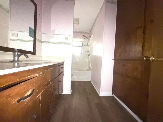 a bathroom with a sink a mirror and a shower