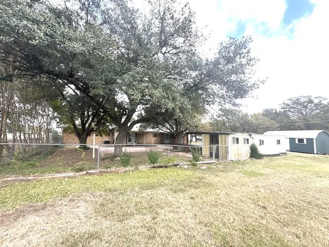 a view of a house with yard and sitting area
