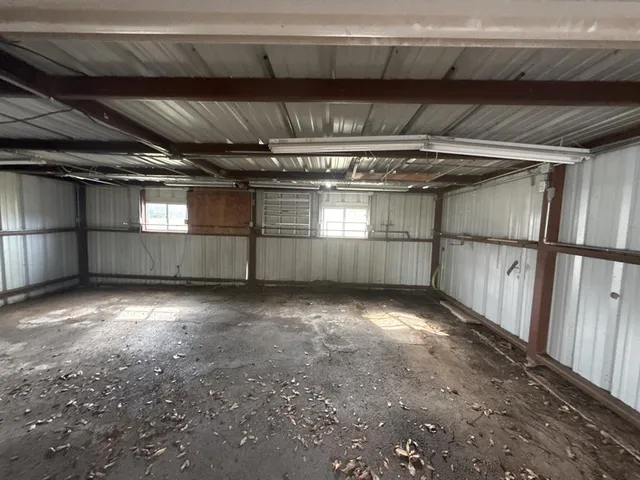 a view of an empty room with a fireplace and a window