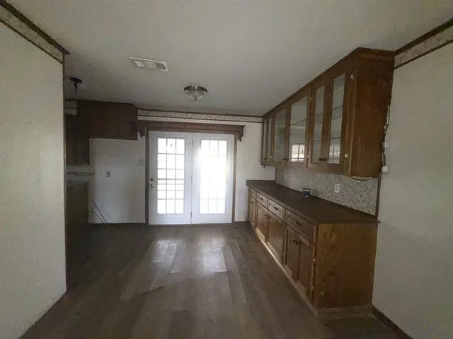 a kitchen with granite countertop a stove a sink and a refrigerator