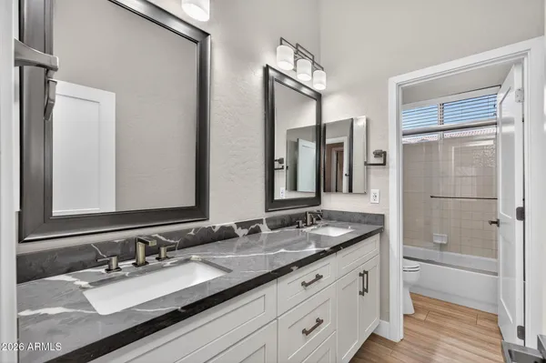 a view of wooden floor and windows in the room