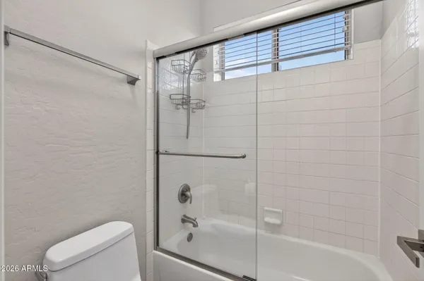 an empty room with wooden floor and outdoor view