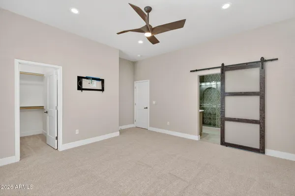 a large kitchen with stainless steel appliances granite countertop a large counter top a sink a stove and a refrigerator