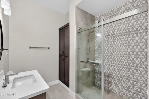 a large kitchen with stainless steel appliances granite countertop a stove a sink and white cabinets