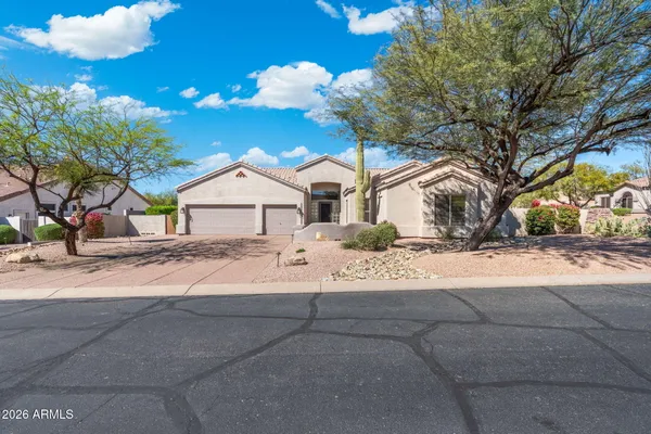 a kitchen with stainless steel appliances granite countertop a sink and a refrigerator