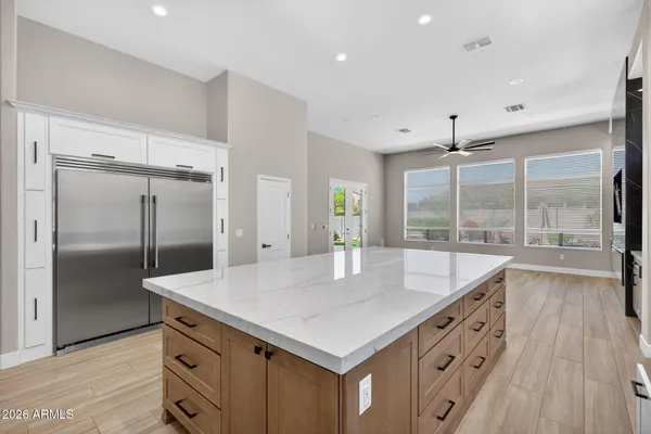 a kitchen with stainless steel appliances cabinets and wooden floor