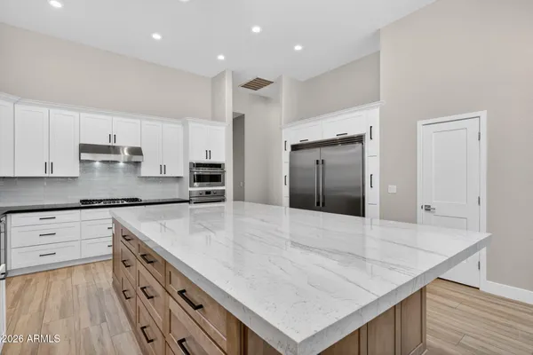 a spacious bathroom with a granite countertop sink and a mirror