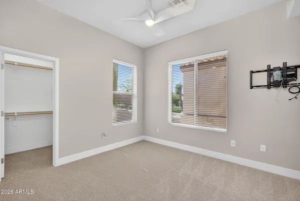 an empty room with fan and windows