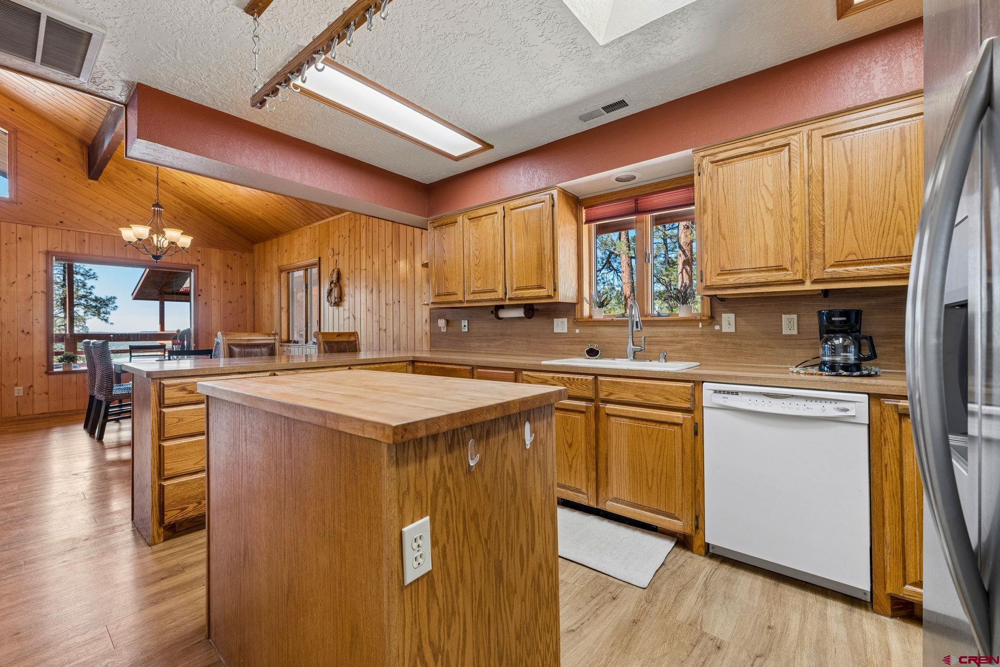 1024 Deer Ridge Drive Bayfield, CO 81122 - Photo 17 of 45 a kitchen with stainless steel appliances granite countertop wooden cabinets a sink and a stove