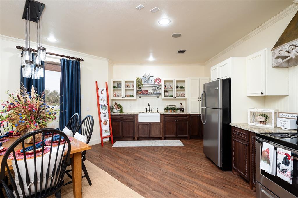 2312 Cactus Rio Lane Weatherford, TX 76087 - Photo 26 of 37 a living room with stainless steel appliances kitchen island granite countertop furniture wooden floor and a kitchen view