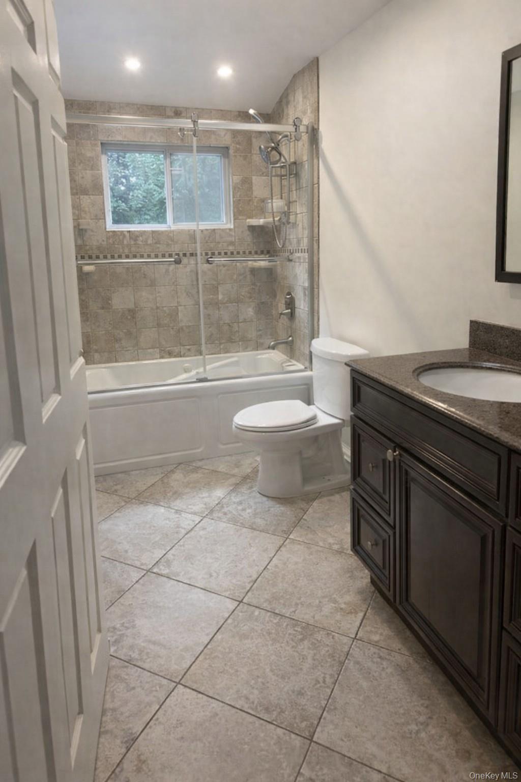 4 Halliday Road Coram, NY 11727 - Photo 10 of 19 a bathroom with a granite countertop sink a toilet and bathtub