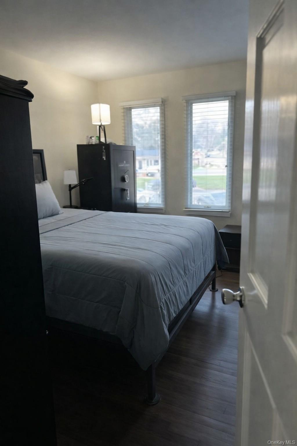 4 Halliday Road Coram, NY 11727 - Photo 11 of 19 a bedroom with a bed and wooden floor