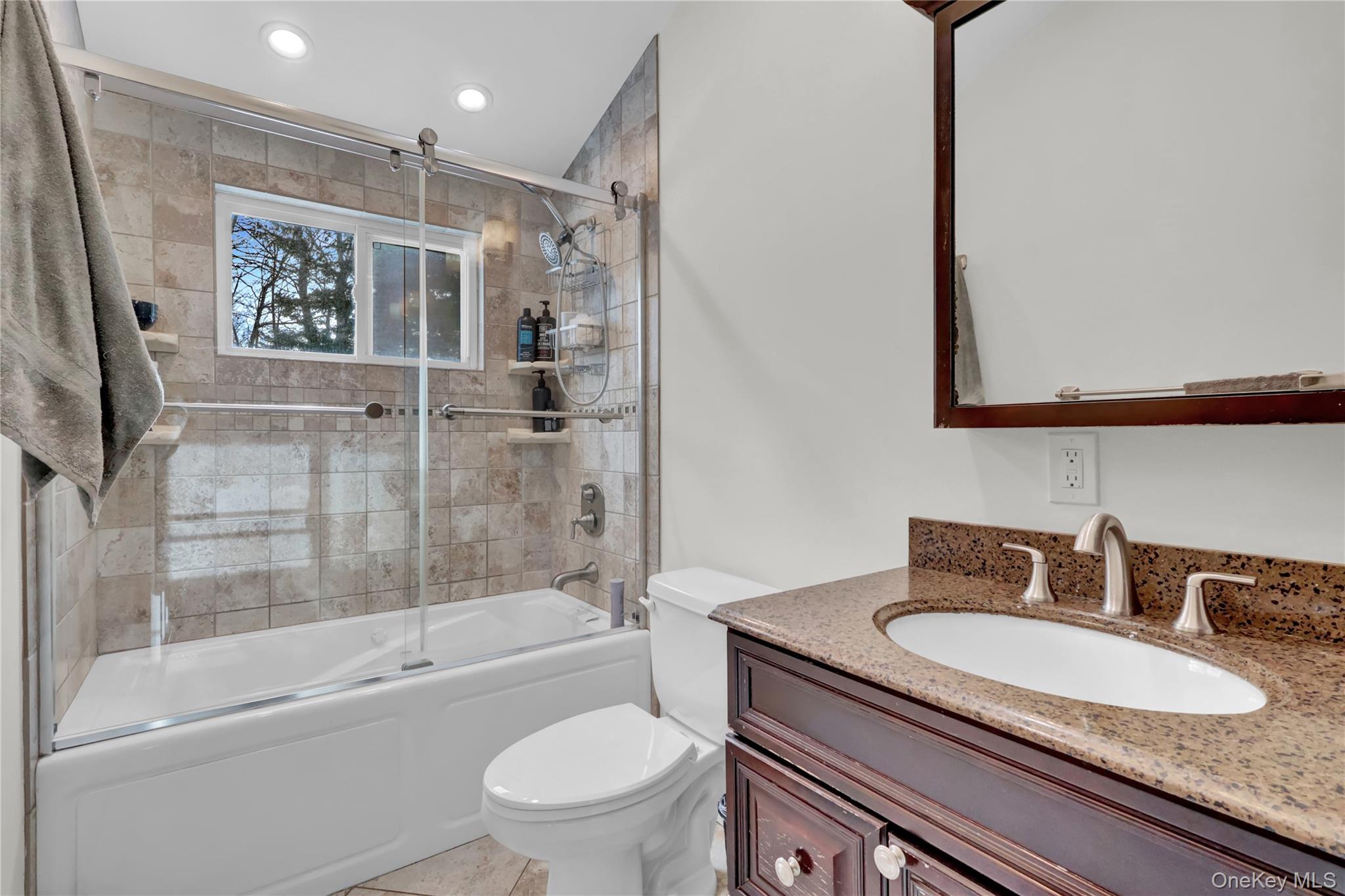 4 Halliday Road Coram, NY 11727 - Photo 14 of 28 a bathroom with a granite countertop sink toilet and shower
